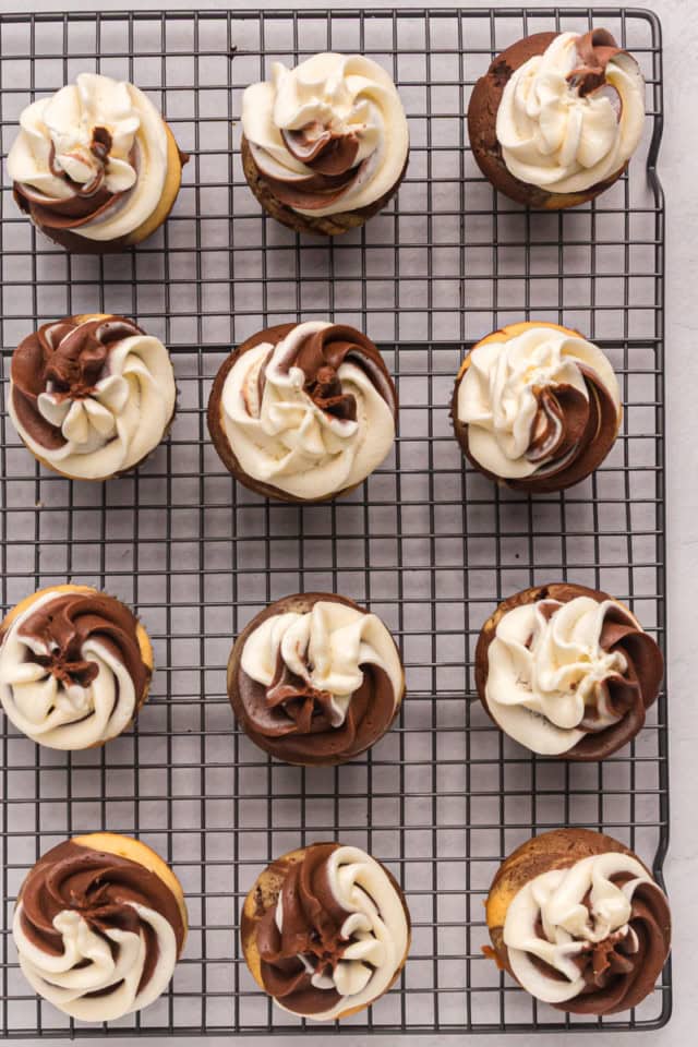 overhead view of frosted marble cupcakes on a wire rack
