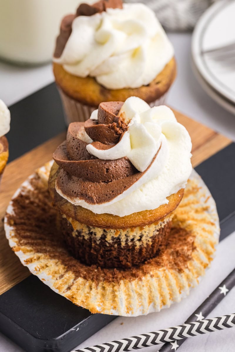 an unwrapped marble cupcake on a wooden surface