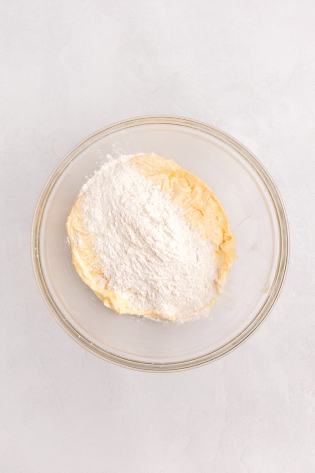 overhead view of dry ingredients added to wet ingredients for marble cupcakes