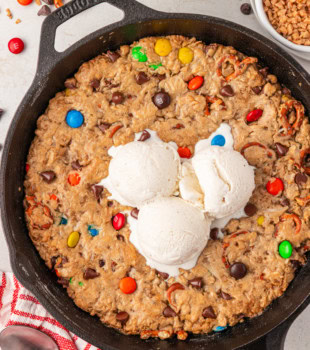 overhead view of monster skillet cookie in a cast iron skillet topped with ice cream