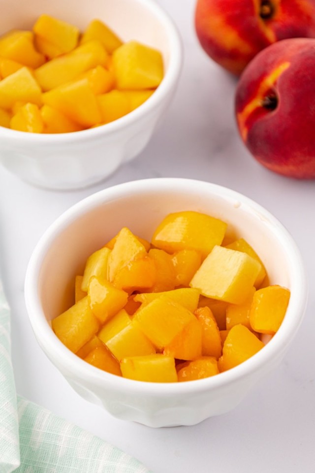 overhead view of peach crisp filling in two white ramekins