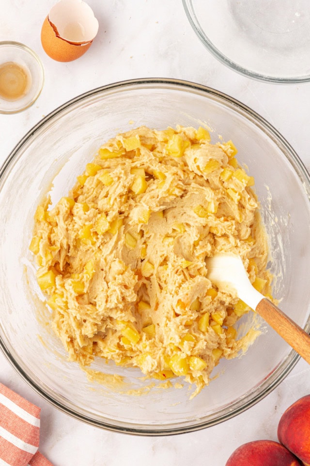 overhead view of peach cookie dough in a glass mixing bowl