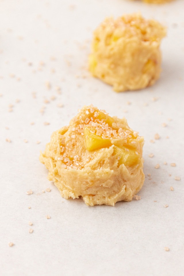 peach cookies scooped onto parchment paper