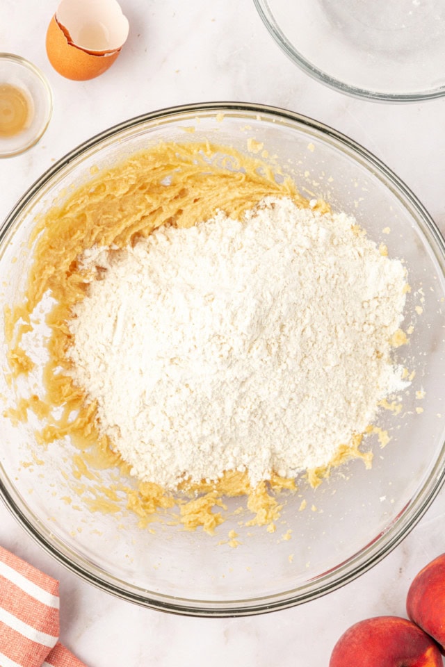 overhead view of dry ingredients added to wet ingredients for peach cookies