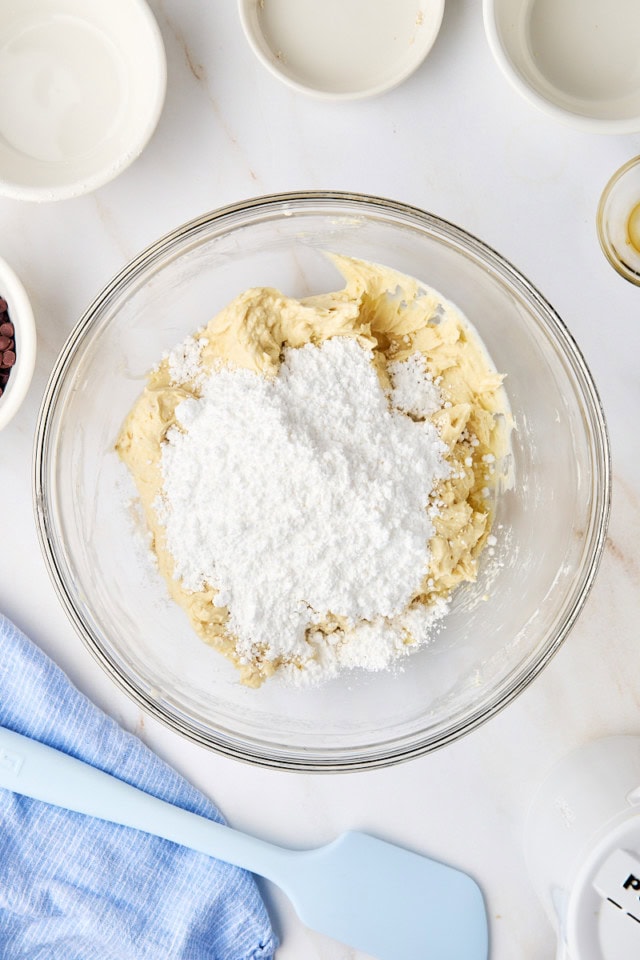overhead view of confectioners' sugar added to cookie dough dip mixture