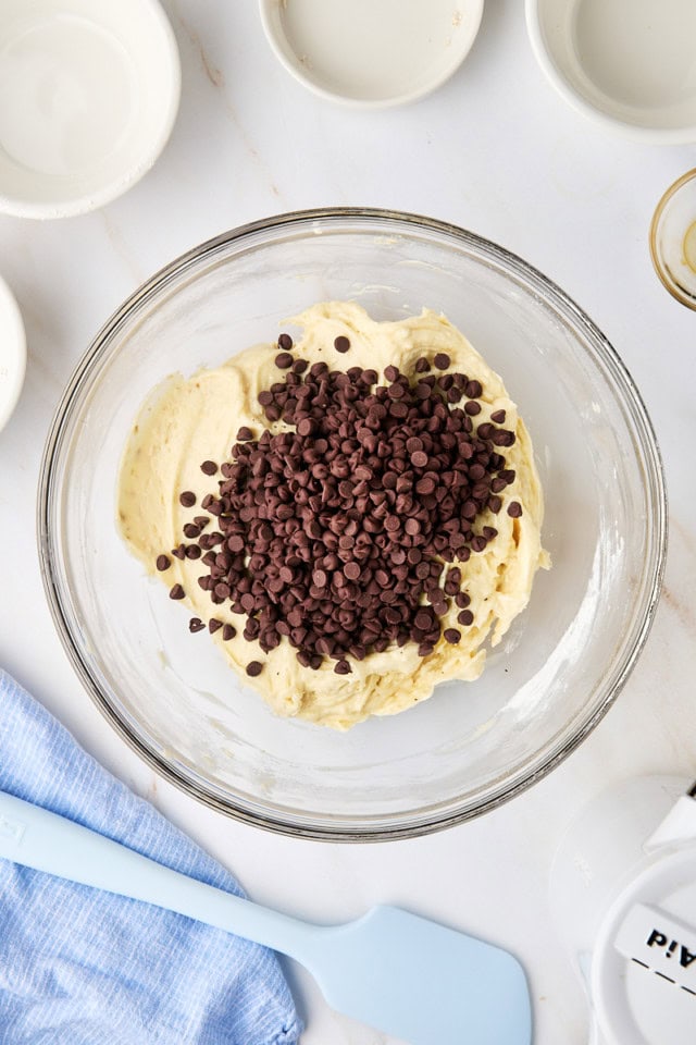 overhead view of chocolate chips added to cookie dough dip mixture