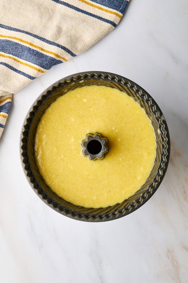 overhead view of cornmeal pound cake batter in a Bundt pan