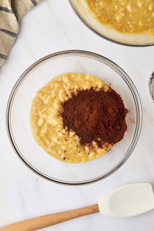 overhead view of cocoa powder added to a portion of banana bread batter