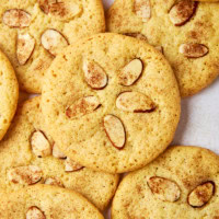 several sand dollar cookies piled and stacked on a white surface