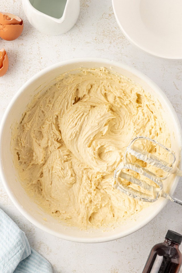 overhead view of cake batter in a white mixing bowl