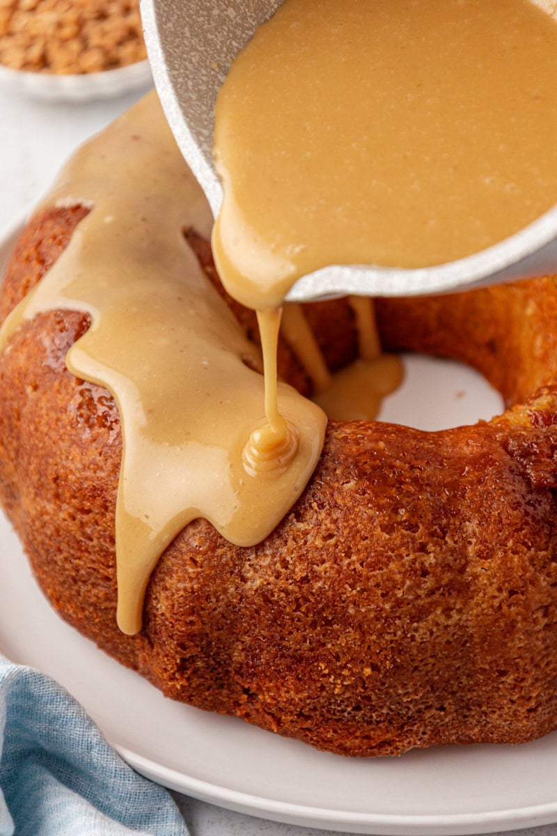 caramel glaze being poured over caramel swirl Bundt cake
