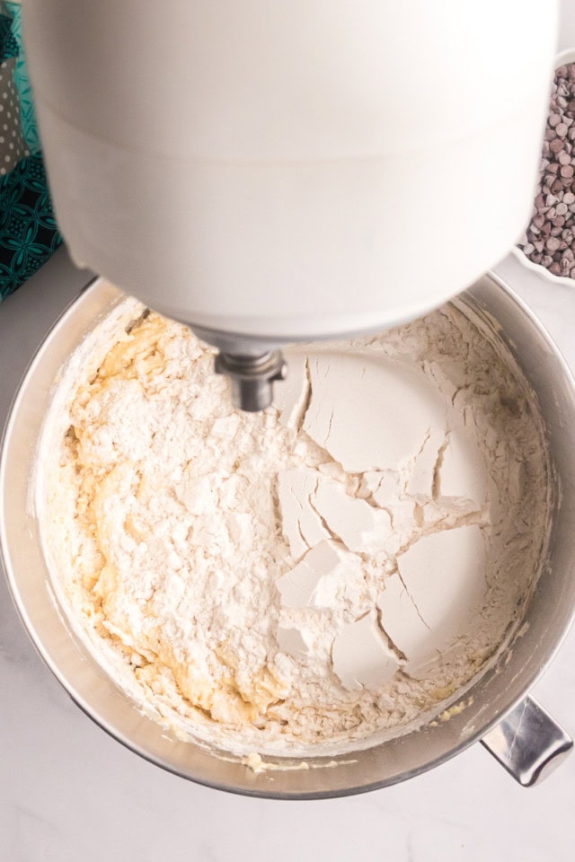 overhead view of dry ingredients added to wet ingredients for chocolate chip crumb pound cake