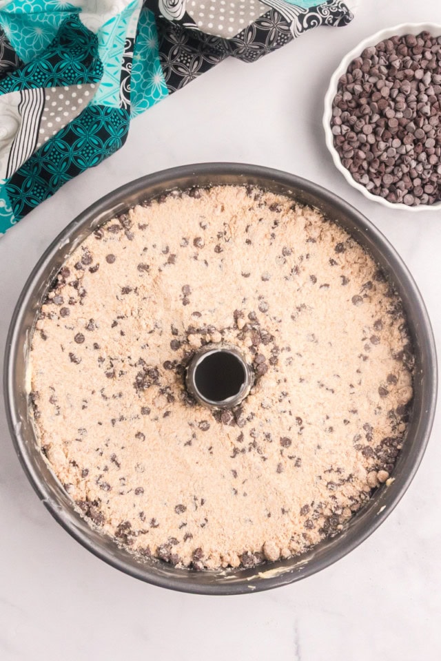 overhead view of chocolate chip crumb pound cake in a tube pan ready to go into the oven