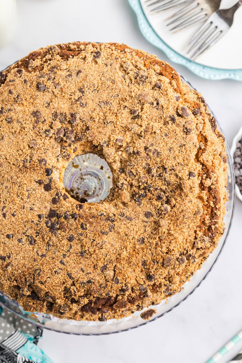 overhead view of chocolate chip crumb pound cake on a glass cake stand