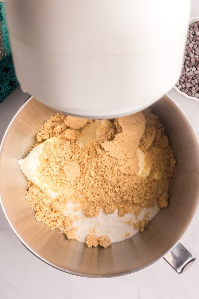 overhead view of butter, cream cheese, brown sugar, and sugar in the bowl of a stand mixer