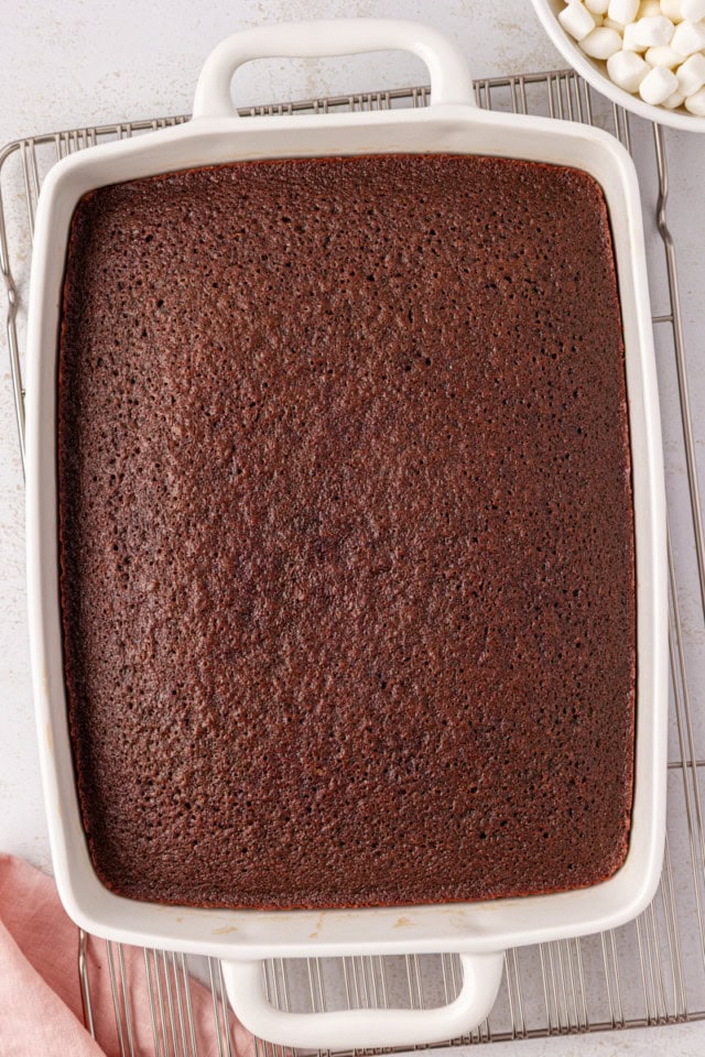 overhead view of freshly baked chocolate cake in a white baking pan