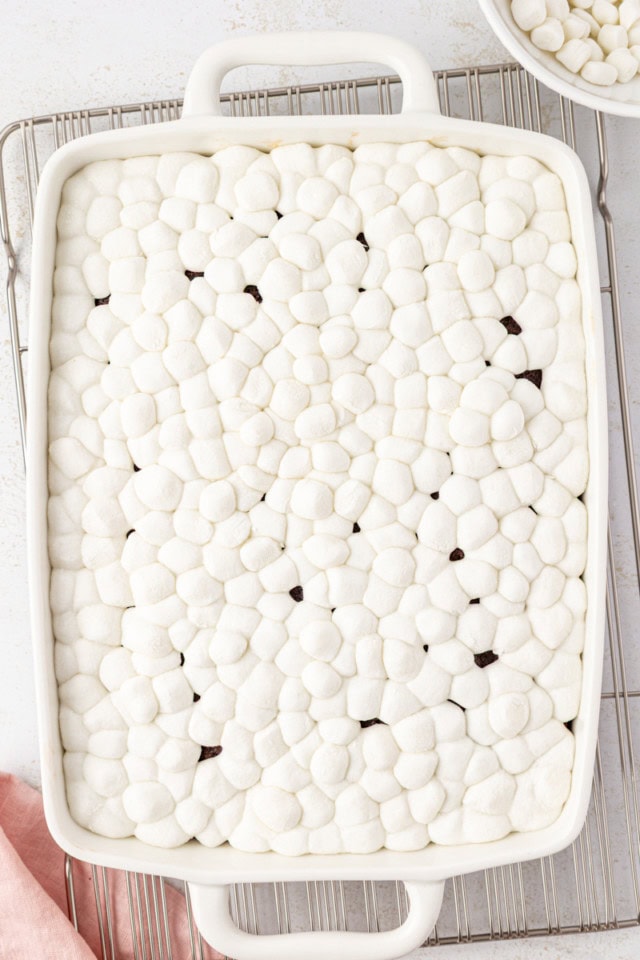 overhead view of heated marshmallows on top of chocolate cake