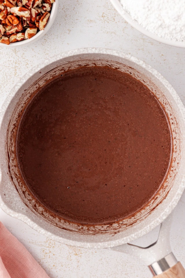 overhead view of heated butter, cocoa, and milk in a saucepan