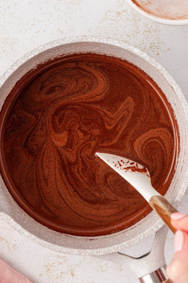 overhead view of heated butter, cocoa, and water in a saucepan