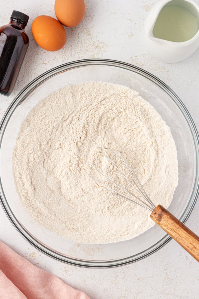 overhead view of combined sugar, flour, baking soda, and salt in a glass mixing bowl