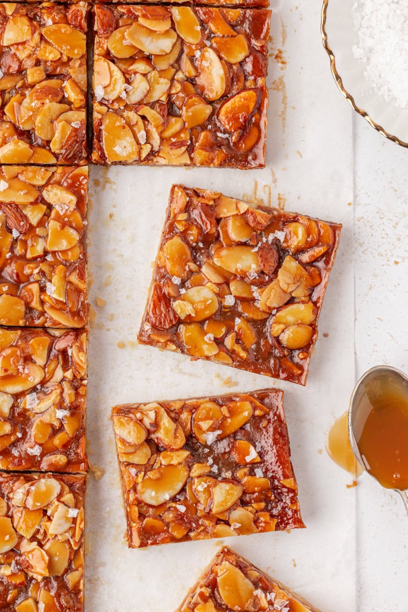 overhead view of salted caramel almond bars on parchment paper