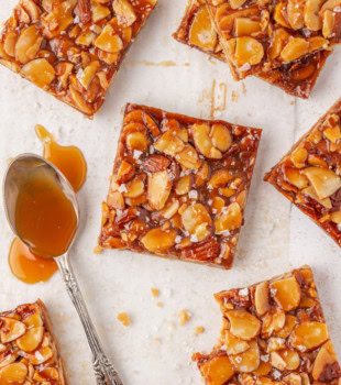 overhead view of salted caramel almond bars on parchment paper