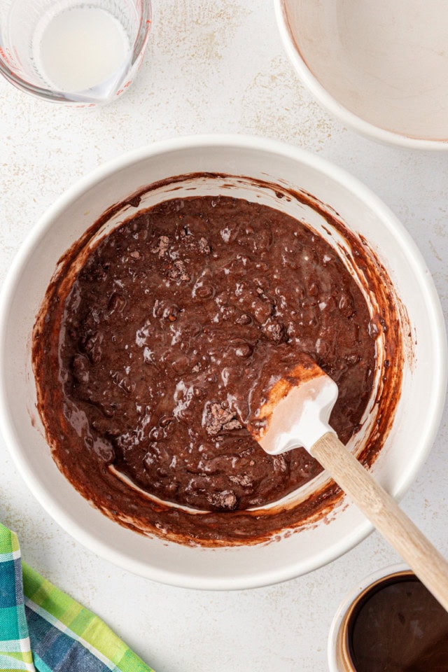 overhead view of partially mixed chocolate cupcake batter in a white bowl