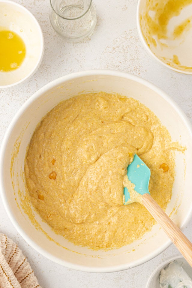 overhead view of sour cream corn bread batter in a white mixing bowl