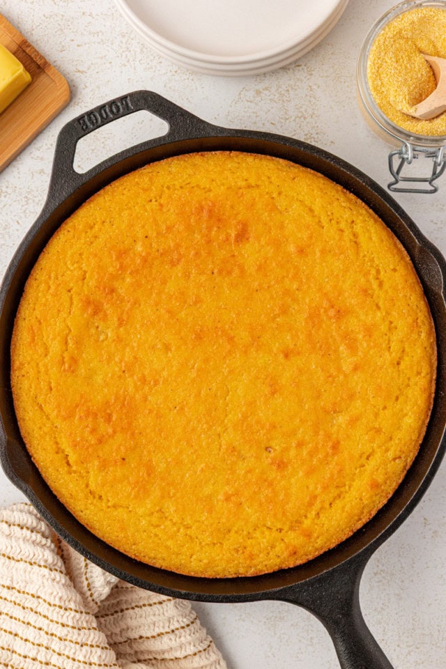 overhead view of freshly baked sour cream corn bread in a cast iron skillet