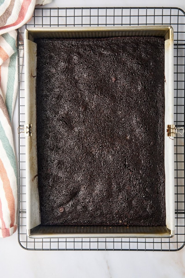 overhead view of freshly baked brownies in a 9x13 pan set on a wire rack