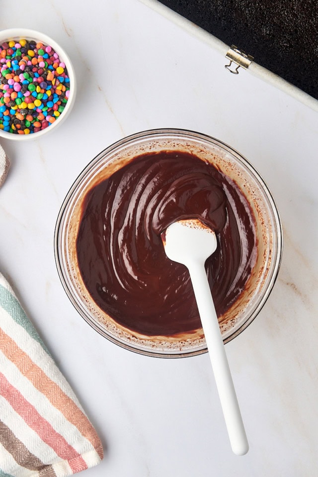 overhead view of chocolate ganache in a glass mixing bowl