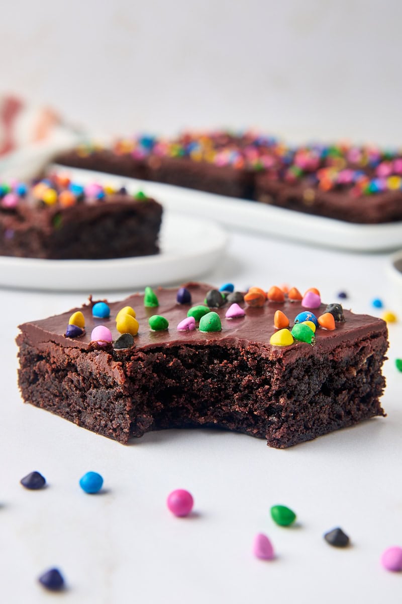 a cosmic brownie with a bite missing, with more brownies in the background