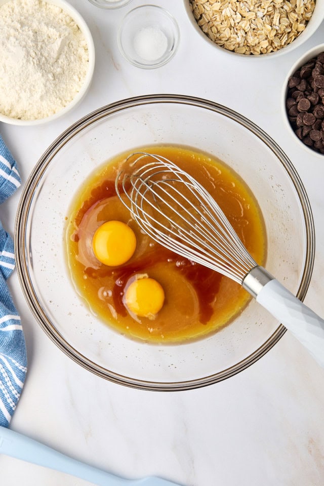 overhead view of eggs and vanilla extract added to butter-sugar mixture