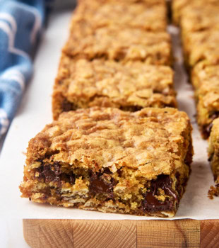oatmeal cookie bars on a parchment-covered cutting board