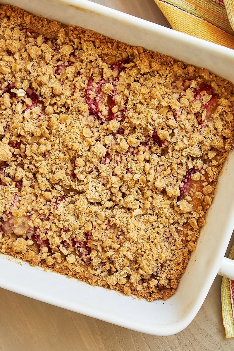 overhead view of freshly baked plum crumble bars in a white baking dish