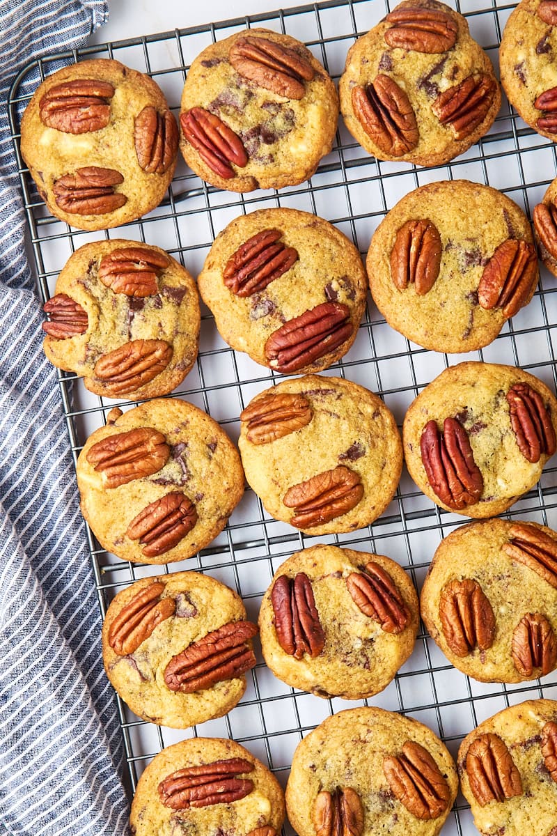 overhead view of triple chocolate pecan cookies cooling on a wire rack