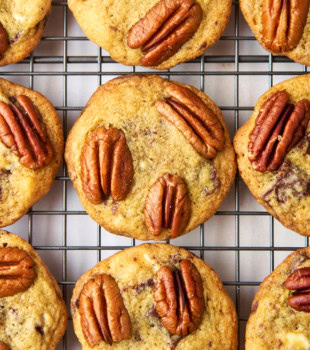 overhead view of triple chocolate pecan cookies on a wire rack