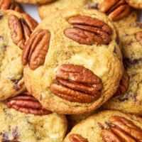 close-up view of a pile of triple chocolate pecan cookies