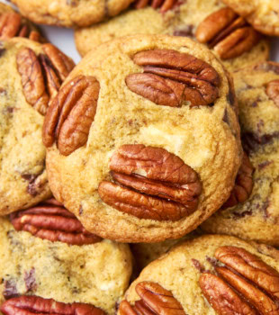 close-up view of a pile of triple chocolate pecan cookies