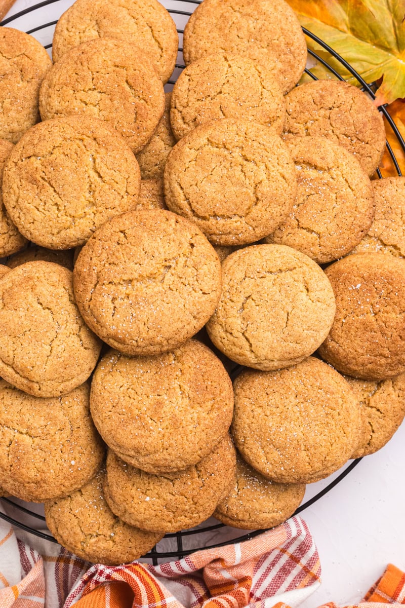 overhead view of apple butter snickerdoodles piled on a round wire rack