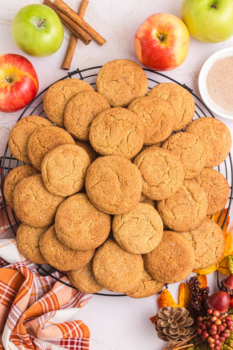 overhead view of apple butter snickerdoodles piled on a round wire rack