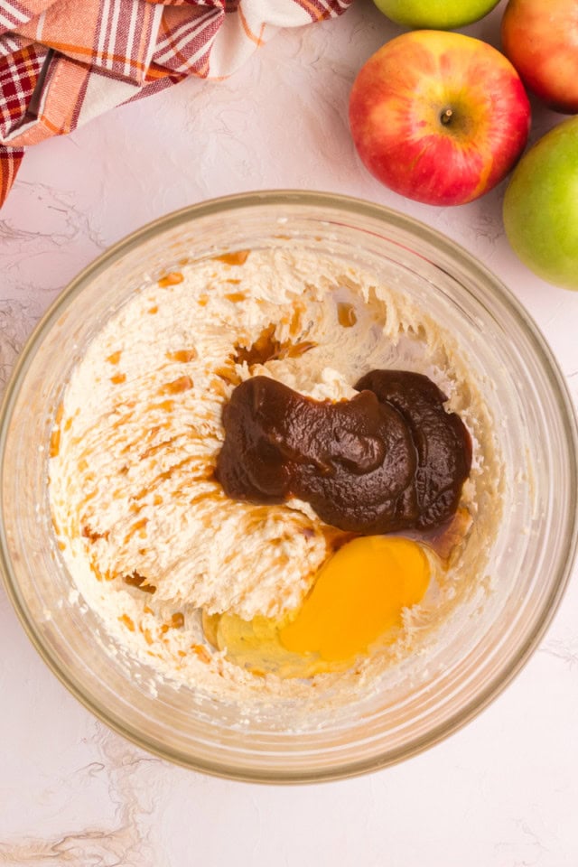 overhead view of apple butter, egg, and vanilla added to creamed butter and sugar