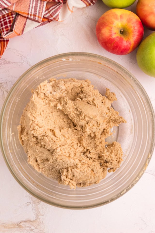 overhead view of apple butter snickerdoodle cookie dough in a glass mixing bowl