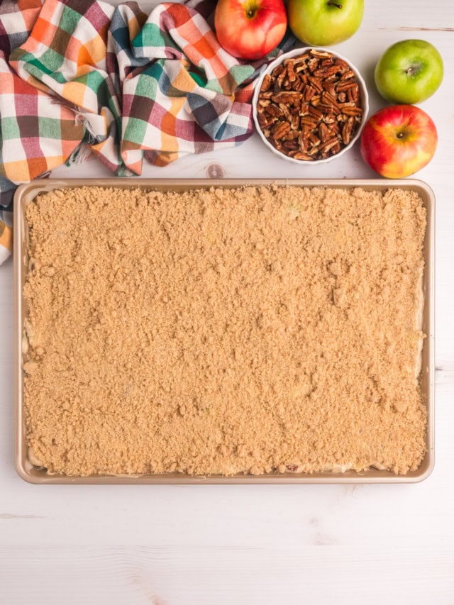 overhead view of apple crumb sheet cake in a half sheet pan ready to go into the oven