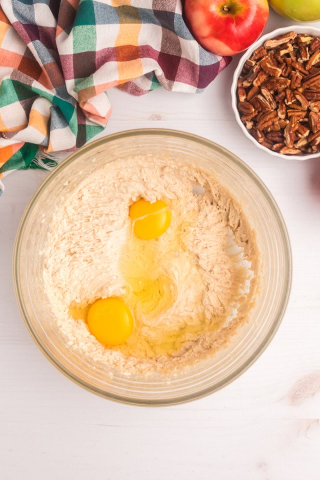 overhead view of eggs added to creamed butter and sugar