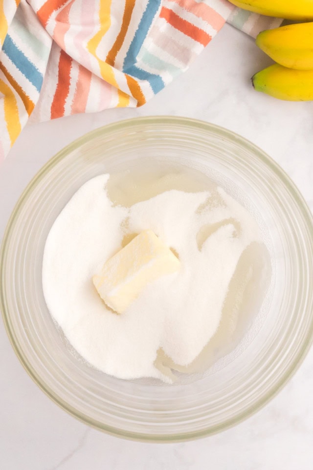 overhead view of butter, oil, and sugar in a glass mixing bowl