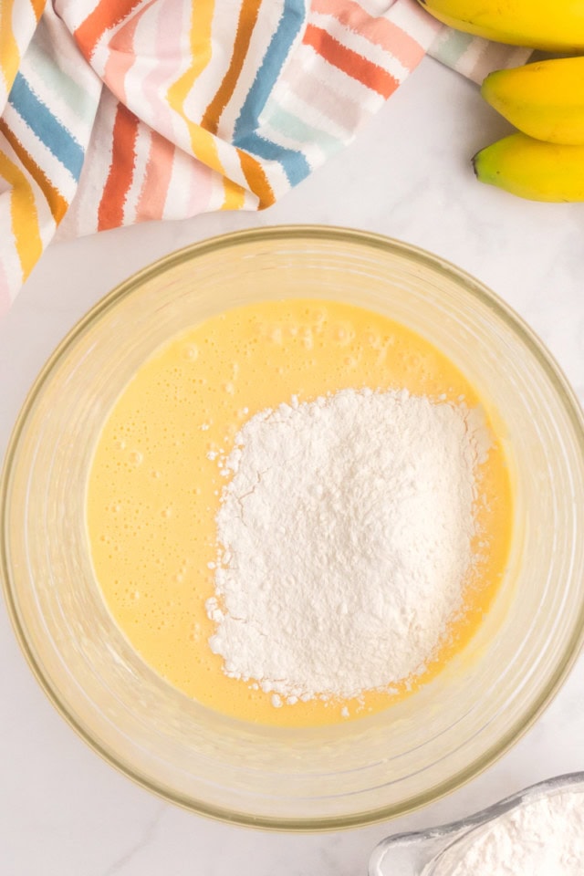overhead view of dry ingredients added to cake batter