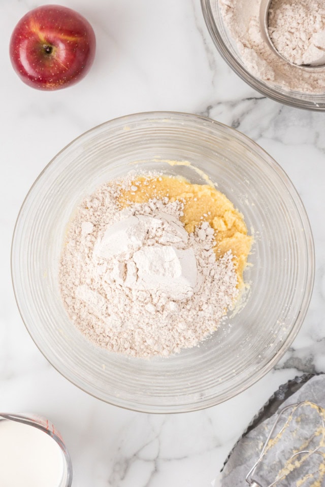 overhead view of dry ingredients added to crumb cake batter