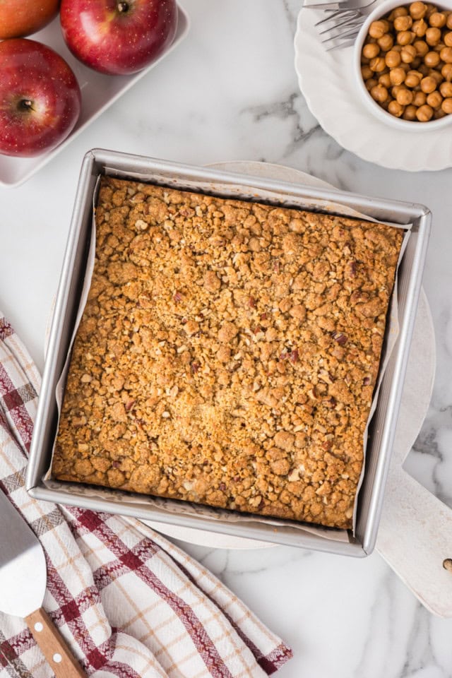 overhead view of freshly baked caramel apple crumb cake in a square baking pan