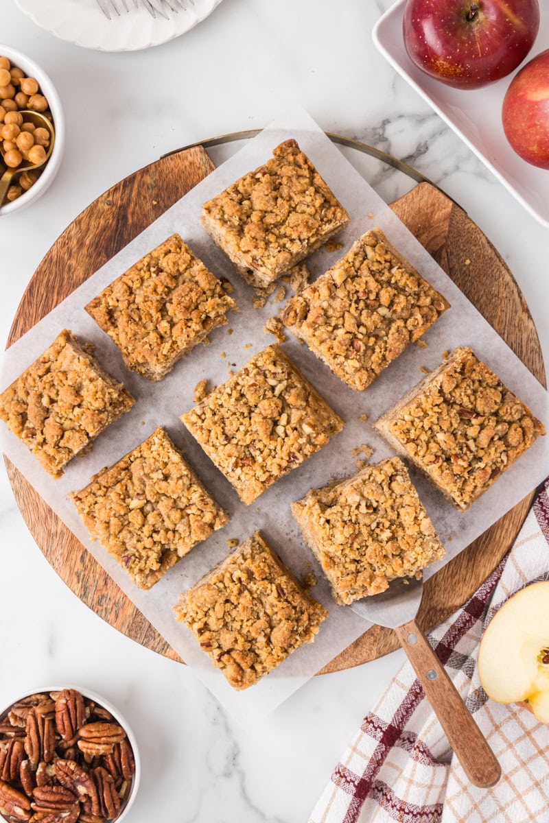 Overhead view of sliced caramel apple crumb cake topped with golden caramel-studded crumbs